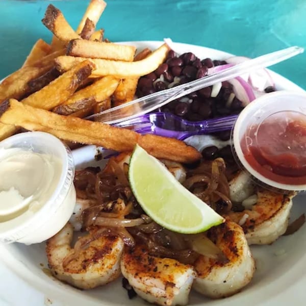 B.O.'s Fish Wagon's grilled shrimp with fries, black beans, onions, and lime.
