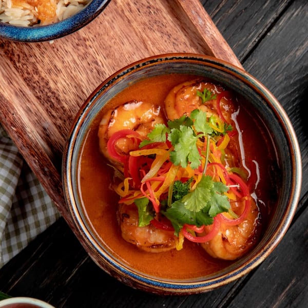 B.O.'s Fish Wagon shrimp dish with red and yellow peppers, cilantro, and orange sauce.
