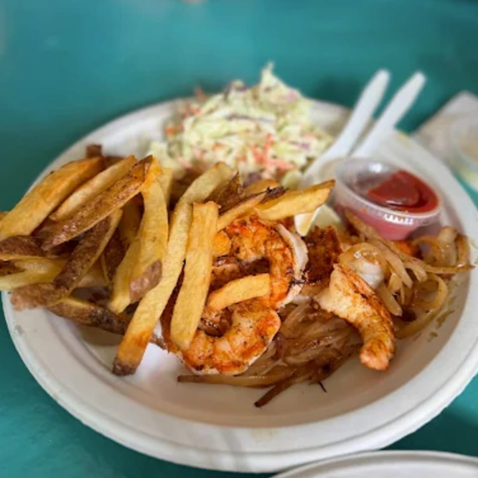 B.O.'s Fish Wagon shrimp and fries platter with coleslaw and ketchup on a white plate.